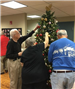 People Hanging Ornaments on Tree