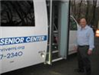 Man Standing by the Transportation Bus