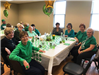Group Sitting at the Table and Smiling for the Camera