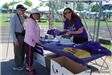 Volunteer Handing out T-Shirts