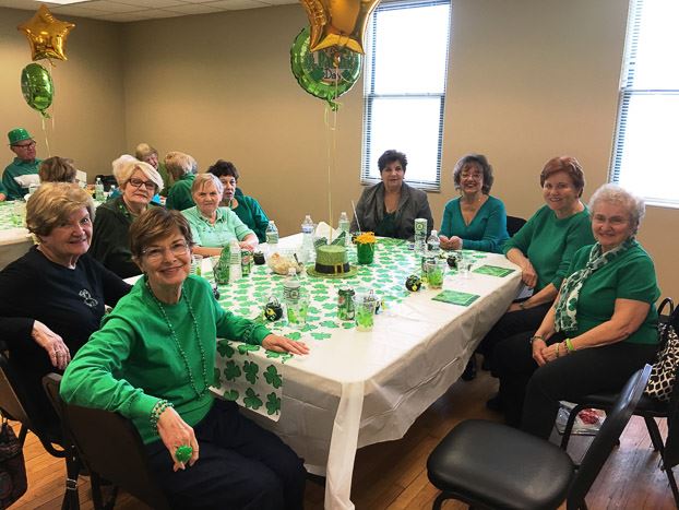 Group Sitting at the Table and Smiling for the Camera