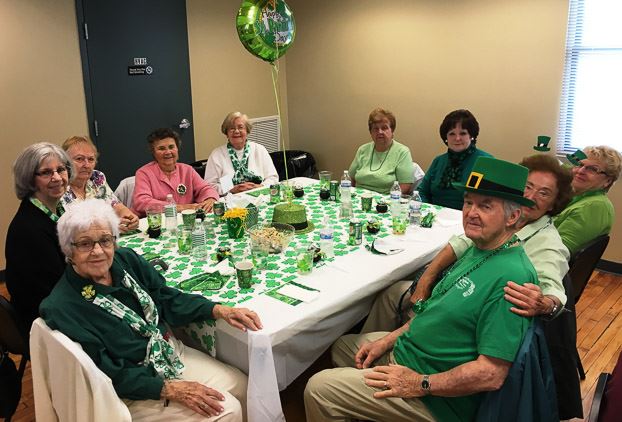 Group Sitting at the Table and Smiling for the Camera (2)