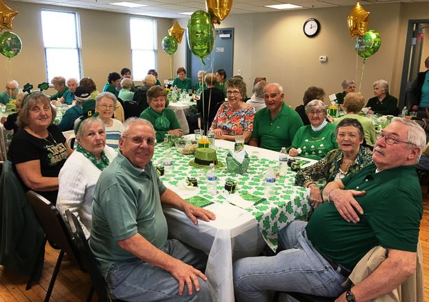 Group Sitting at the Table and Smiling for the Camera (3)