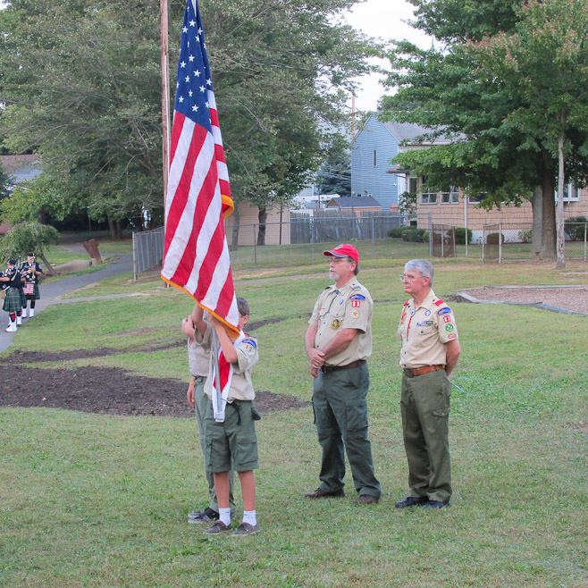 Boy Scouts Holding American Flag During Ceremony